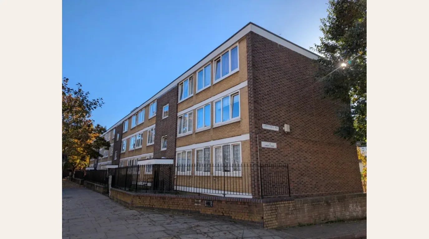 Existing Lubbock House on Poplar High Street in South Poplar, a mid-century low-rise residential block before a concept visualisation treatment